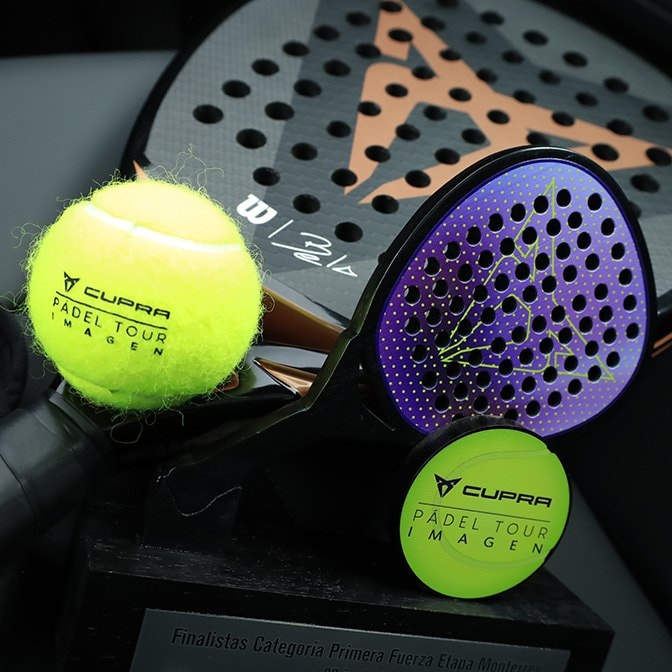 Surreal architectural scene featuring a blue CUPRA car vertically mounted on a concrete wall next to another blue car parked normally in a driveway, with a person walking toward the entrance.